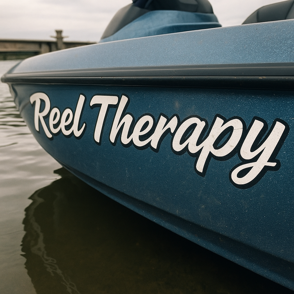 Up-close photo of a bass boat hull with 'Reel Therapy' painted in white script